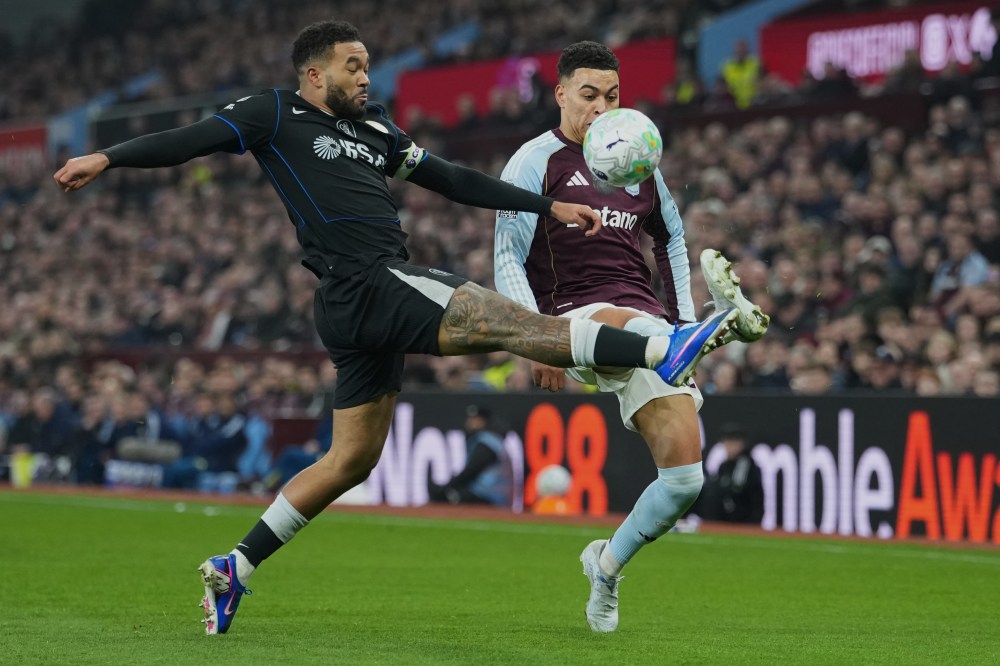 Chelsea's Reece James, left, tackles Aston Villa's Morgan Rogers during their English Premier League soccer match between Aston Villa and Chelsea in Birmingham, England, Wednesday, March 4, 2026. (AP Photo/Dave Shopland)