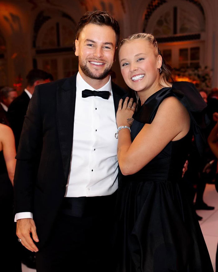 JoJo Siwa and Chris Hughes smiling at a formal event, highlighting wedding aftermath and emotional moments.
