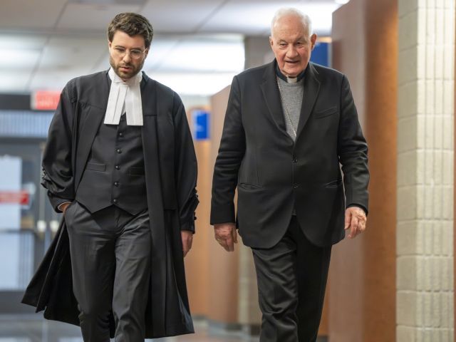 Quebec Cardinal Marc Ouellet, right, walks with one of his lawyers during a break at the courthouse in Montreal on Thursday, March 5, 2026. THE CANADIAN PRESS/Christinne Muschi