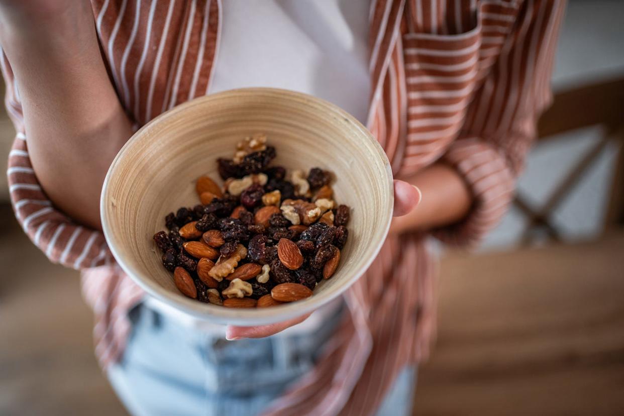 Healthy lifestyle concept with bowl of mixed nuts and dried fruit