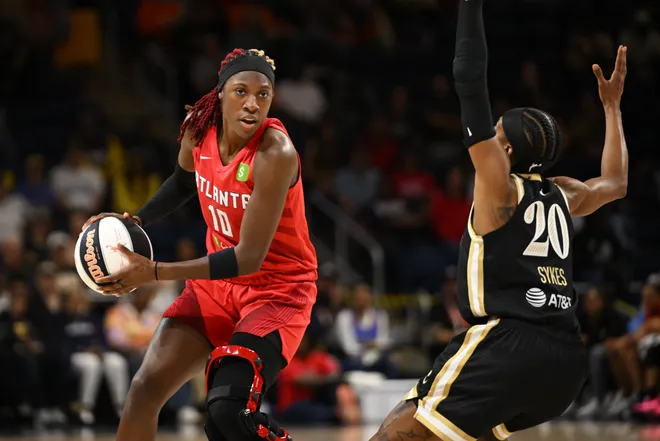 Jun 15, 2025; Washington, District of Columbia, USA; Atlanta Dream guard Rhyne Howard (10) looks to pass in front of Washington Mystics guard Brittney Sykes (20) during the first quarter at CareFirst Arena. Mandatory Credit: Rafael Suanes-Imagn Images
