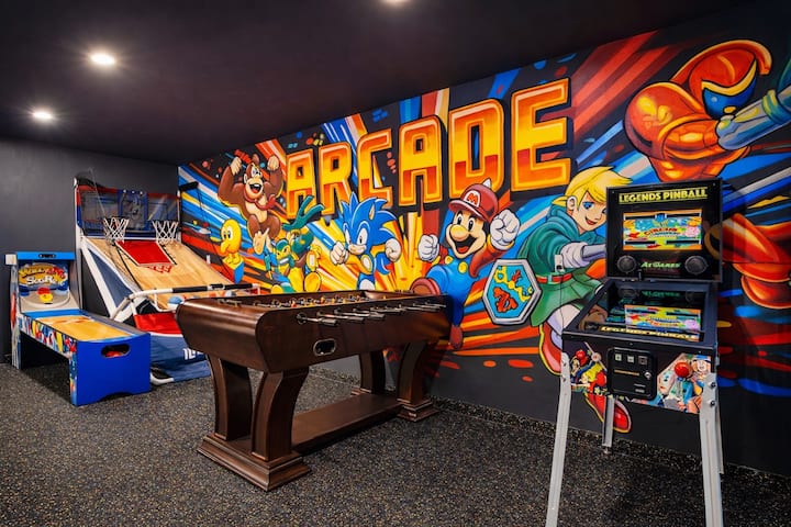 image 45 of 53, Step into a vibrant arcade zone with digital pinball, foosball, basketball, skeeball, and classic games. Grab a ball or joystick, challenge the group, and snap a selfie in front of the bold gaming mural.