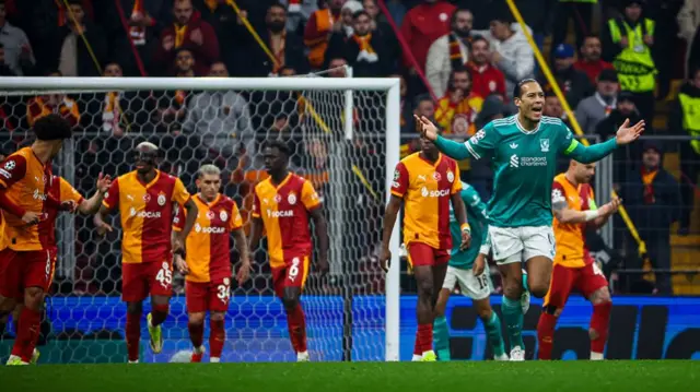 Virgil van Dijk reacts with his arms outstretched after Galatasaray score
