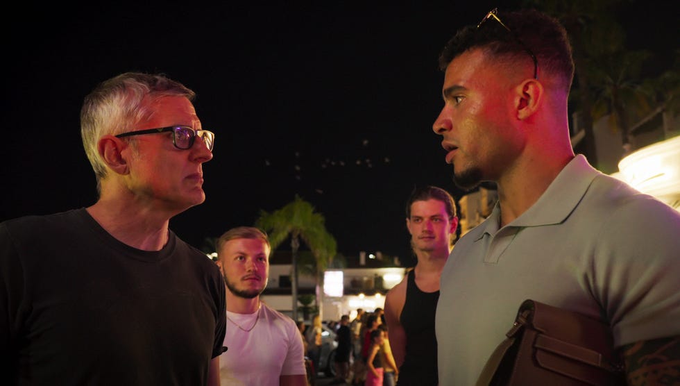group of people engaged in conversation at night