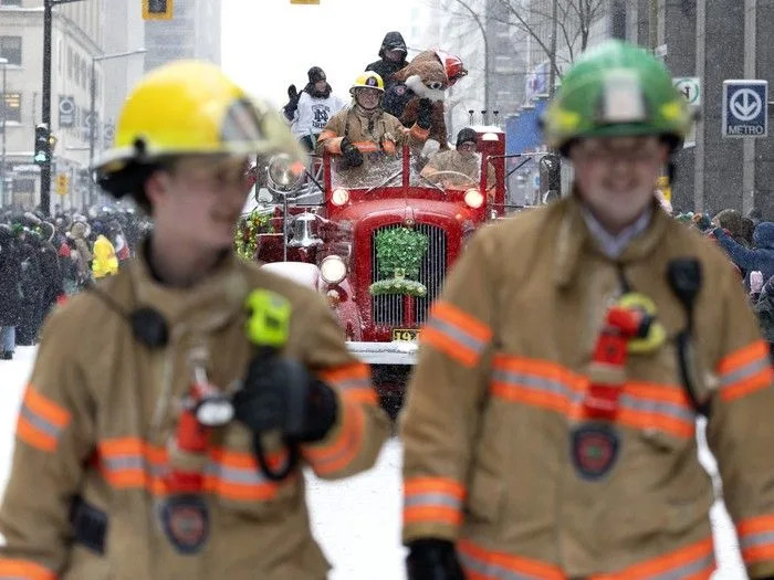  Firefighters walk in front of a 1946 fire truck during the St. Patrick’s Parade in Montreal on Sunday, March 22, 2026.