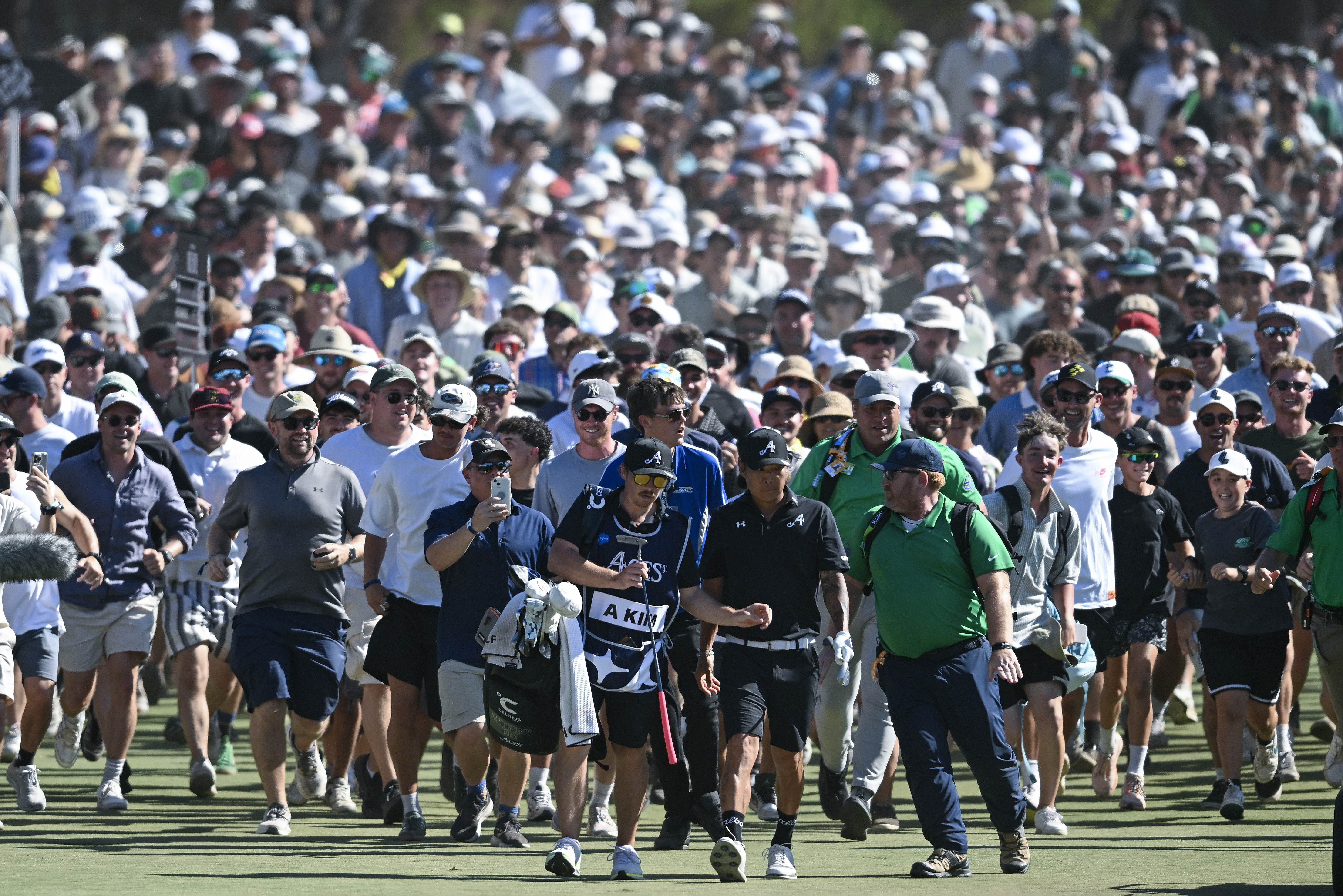 ADELAIDE, AUSTRALIA - FEBRUARY 15: Anthony Kim of the Aces heads down the 18th and is over run by the crowd during day four of LIV Adelaide at The Grange Golf Club on February 15, 2026 in Adelaide, Australia. (Photo by Mark Brake/Getty Images)