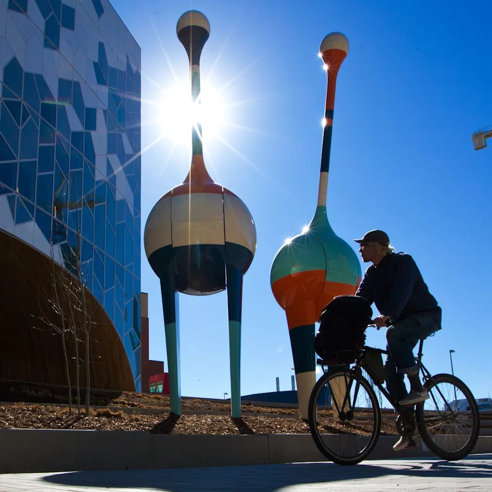  Morning sunlight lights up the pathway and the TRIO art installations outside Calgary’s Central Library on April 8, 2019.