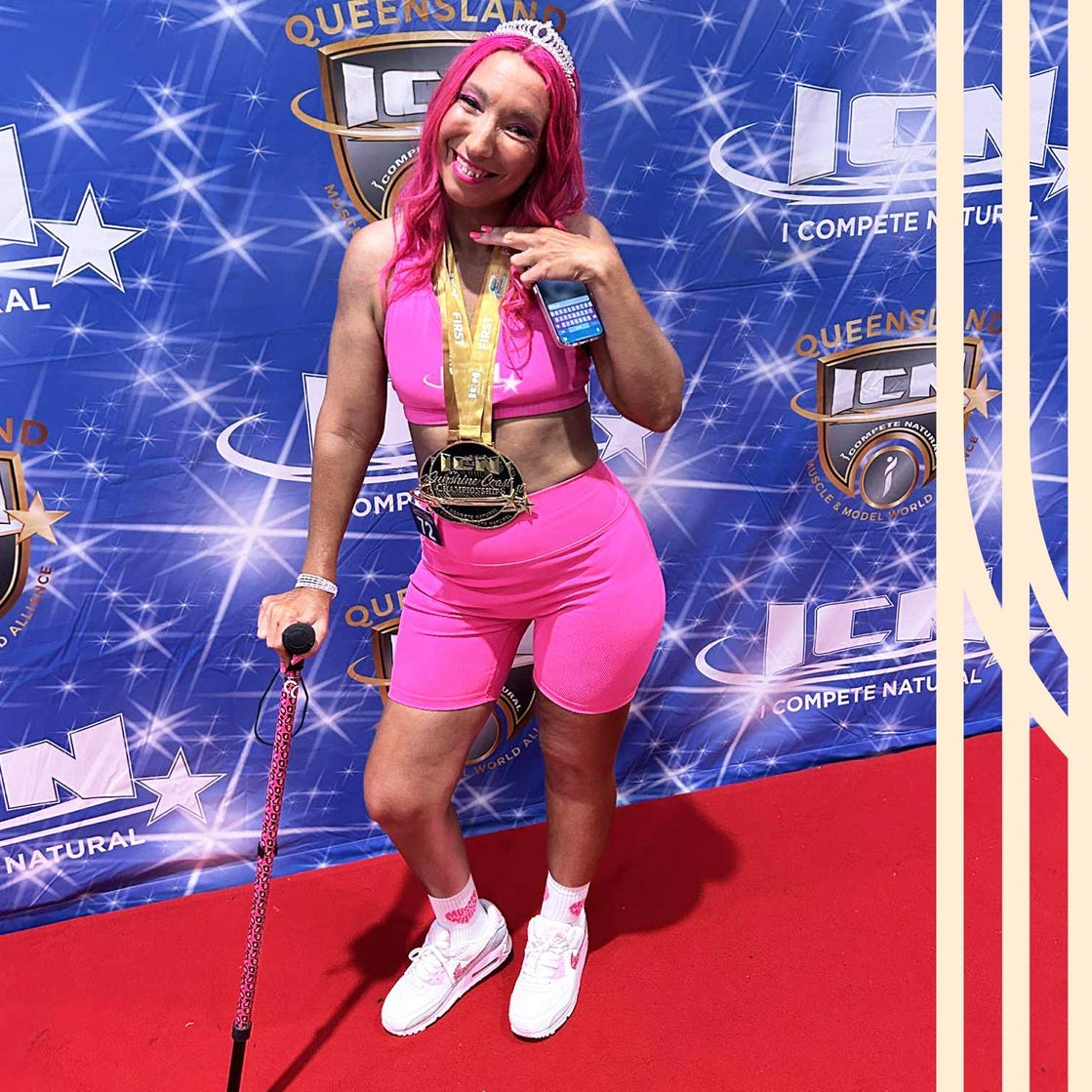 Competitor posing at a bodybuilding event with a medal.