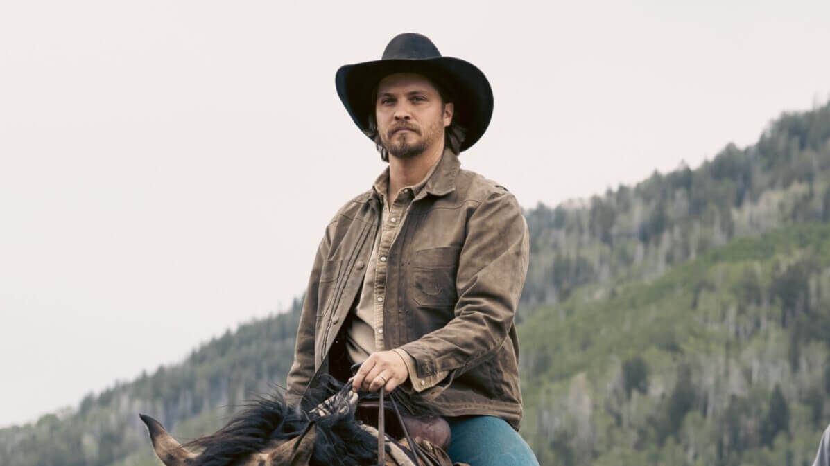 Luke Grimes as Kayce Dutton riding a horse in a promotional photo for 'Marshals'.