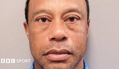 Tiger Woods in a red shirt and white cap