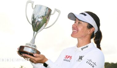 Hannah Green lifting a trophy