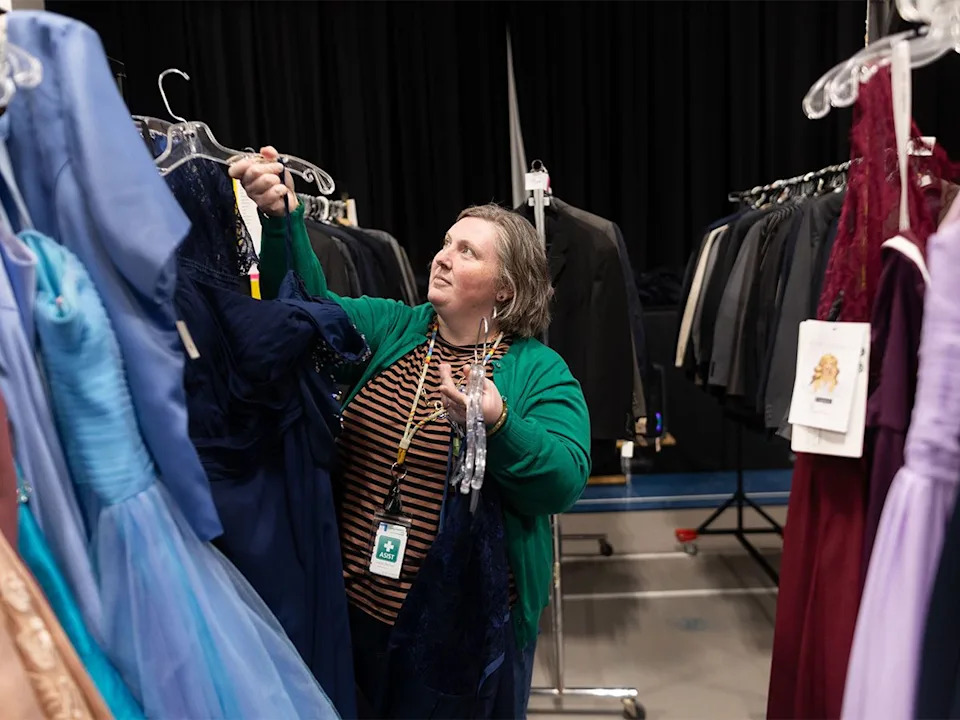 Brittany Fraser organizes formalwear for weekend one of the GRADitude Project in Calgary on Sunday, March 15, 2026. Organized by the Trellis Society, the program outfits Grade 12 students with graduation attire regardless of financial circumstances.
