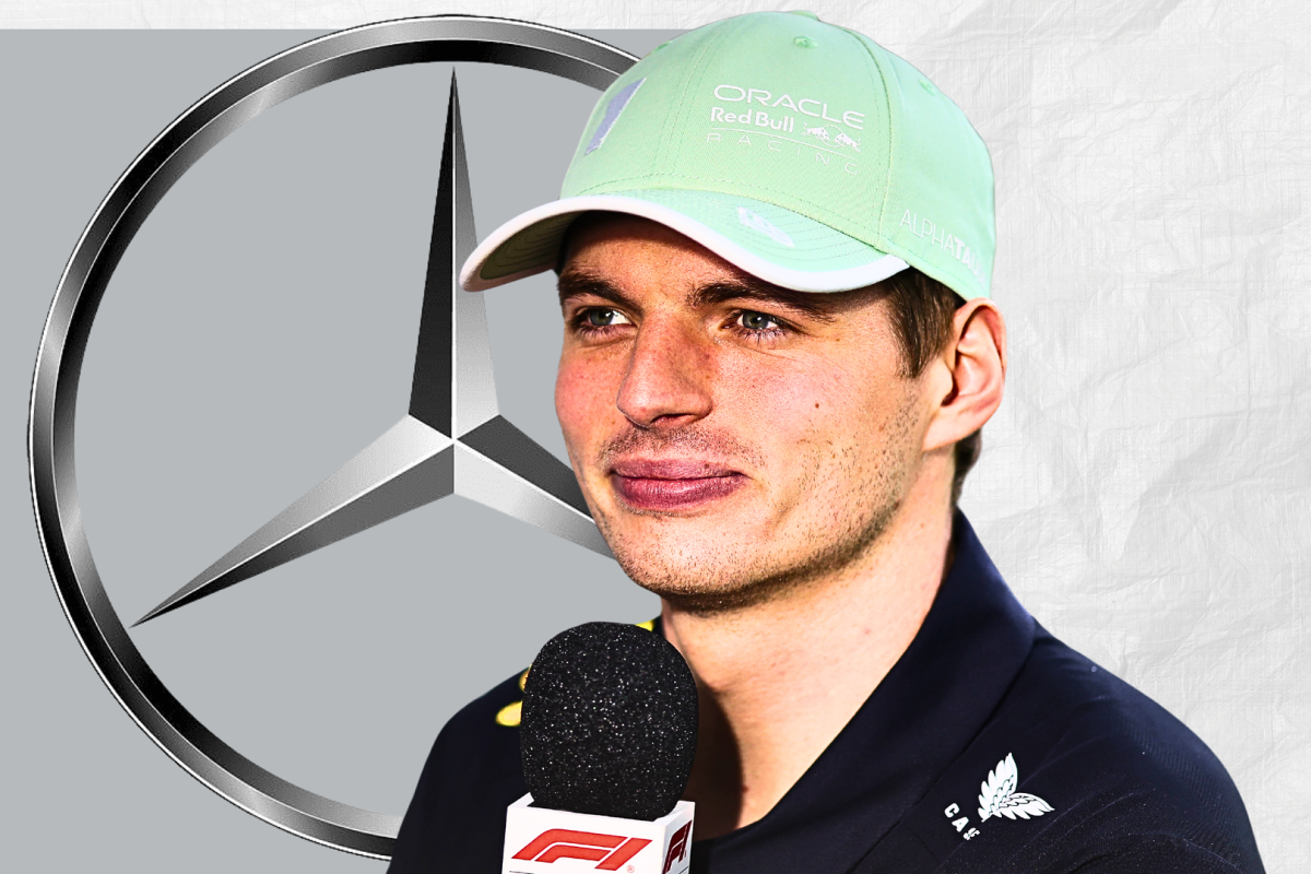 Max Verstappen looking happily at a Mercedes logo