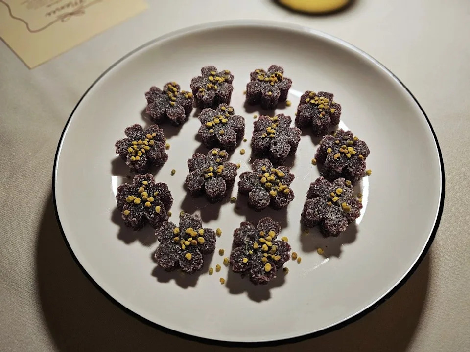 Flower-shaped apple haskap pâte de fruit dusted in sumac sugar and topped with bee pollen closed out the meal as a playful, jewel-toned parting bite.