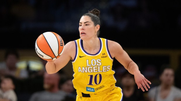 Los Angeles Sparks guard Kelsey Plum dribbles during the first half of a WNBA game against the Indiana Fever on Friday, Aug. 29, 2025, in Los Angeles. (AP Photo/Kyusung Gong)