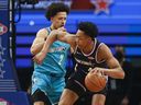 Team Payton's Scottie Barnes, right, of the Toronto Raptors, controls the ball against Team Barry's Cade Cunningham, of the Detroit Pistons, during a semifinal of the NBA basketball Rising Stars event, Friday, Feb. 18, 2022, in Cleveland. 