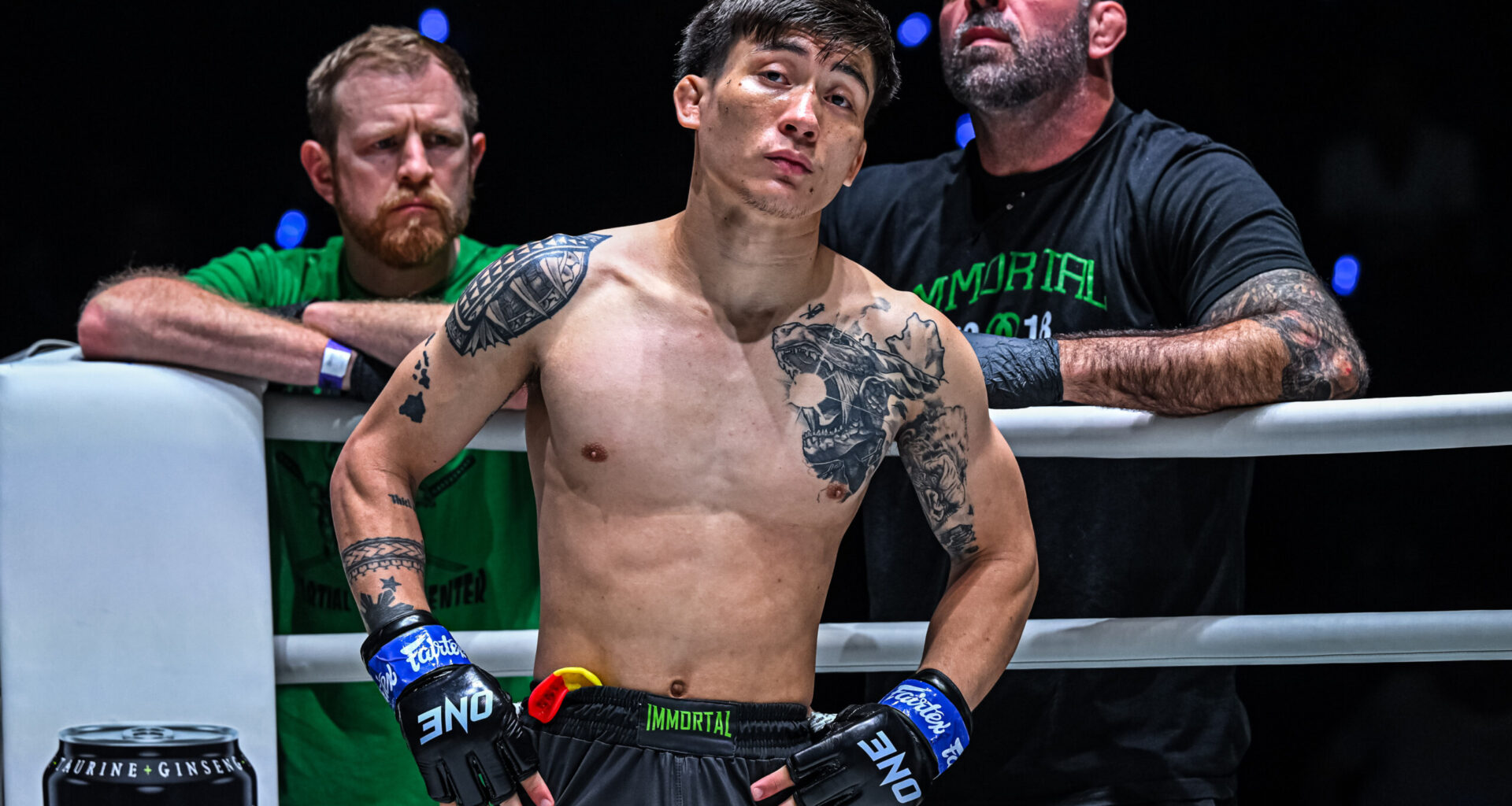 MMA fighter Joshua Perreira stands in the ring corner with Matt Browb behind him