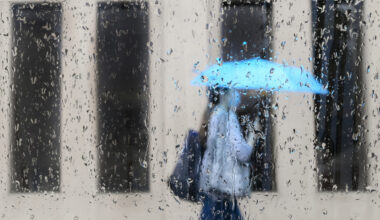 An early spring storm is bringing high winds and heavy rain to parts of Ontario as Environment Canada warns of significant snowfall in other parts of the province. A pedestrian walks on a rainy day in Toronto on Friday, June 18, 2021. THE CANADIAN PRESS/Nathan Denette