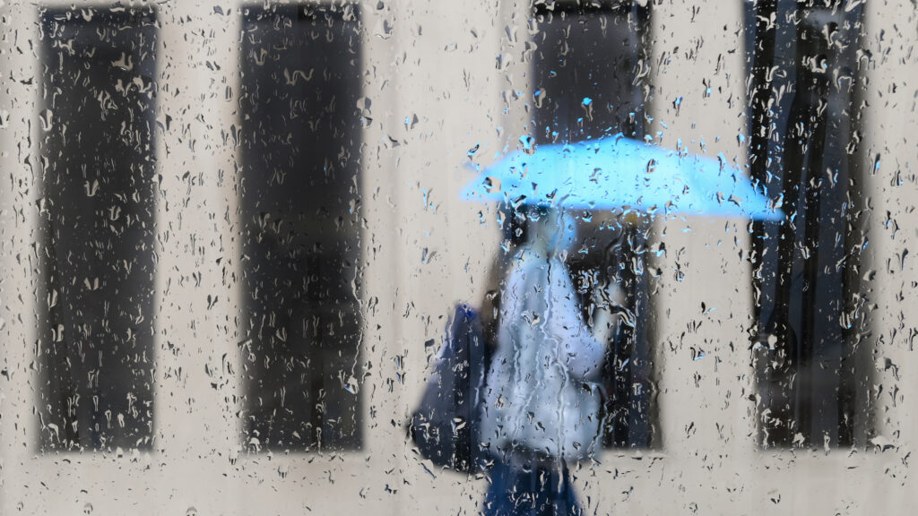 An early spring storm is bringing high winds and heavy rain to parts of Ontario as Environment Canada warns of significant snowfall in other parts of the province. A pedestrian walks on a rainy day in Toronto on Friday, June 18, 2021. THE CANADIAN PRESS/Nathan Denette