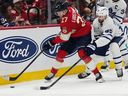 Florida Panthers center Eetu Luostarinen tries to shield the puck against Maple Leafs defenceman Oliver Ekman-Larsson during the second period on  Thursday, Feb. 26, 2026, in Sunrise, Fla.