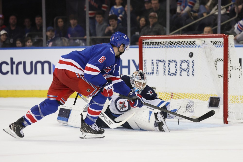HEATHER KHALIFA / THE ASSOCIATED PRESS
Winnipeg Jets goaltender Eric Comrie, right, makes a save against New York Rangers centre J.T. Miller (8) in the shootout Sunday.