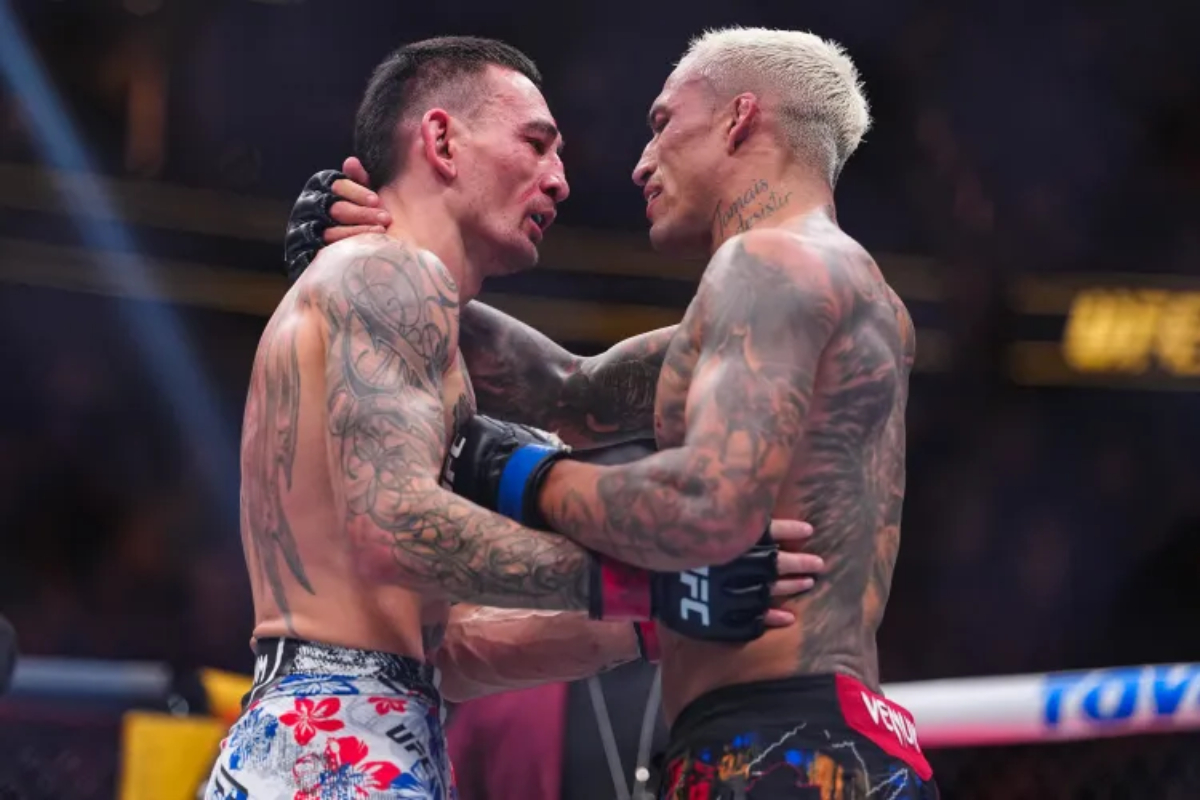 Charles Oliveira and Max Holloway embrace at UFC 326