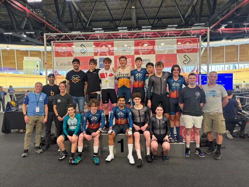 Group photo of Cycling BC athletes, staff, and coaches at the Alberta Velodrome.