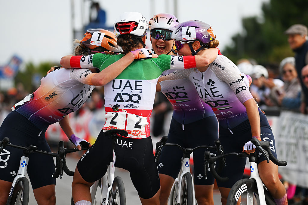 Four UAE Team ADQ riders hug in celebration after Elisa Longo Borghini, pictured, won Trofeo Oro in Euro 2026