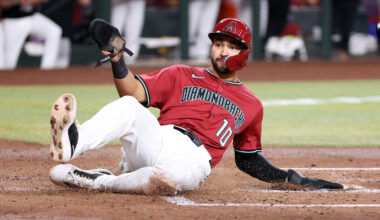 Jordan Lawlar #10 of the Arizona Diamondbacks safely slides across home plate to score a run agains...