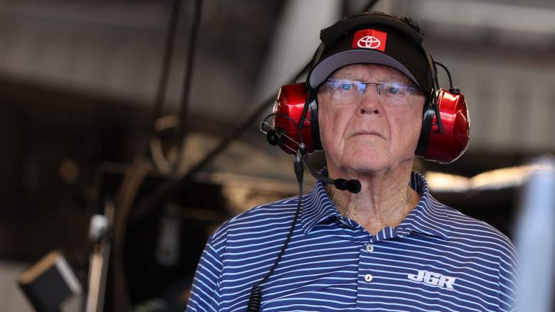 Joe Gibbs wearing headset on pit road during NASCAR race