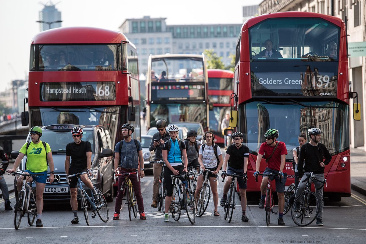 Cyclists waiting at traffic lights in London.