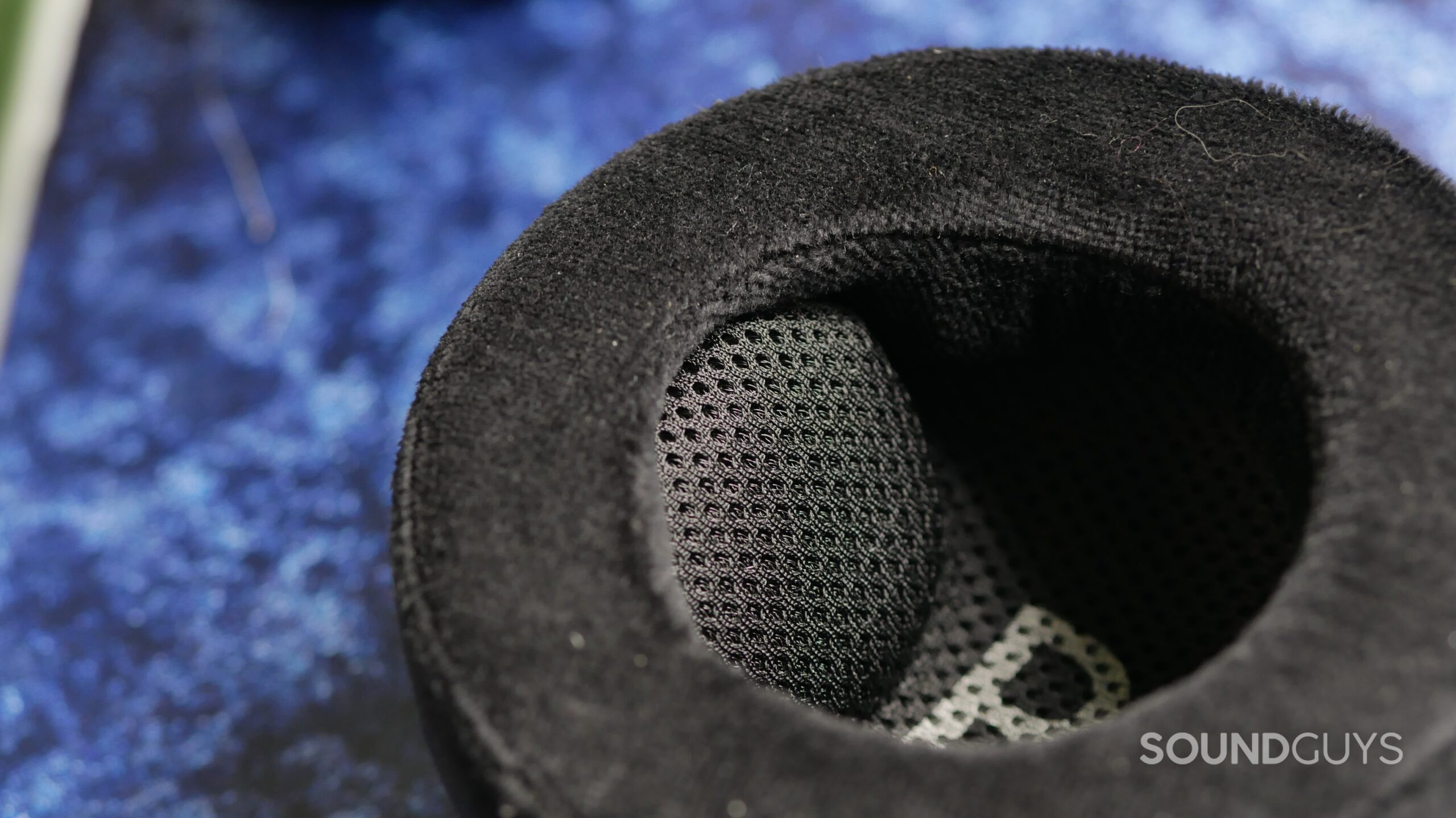 Macro view inside the Grell OAE2 ear pad, highlighting the fabric-covered driver and thick black cushion texture.