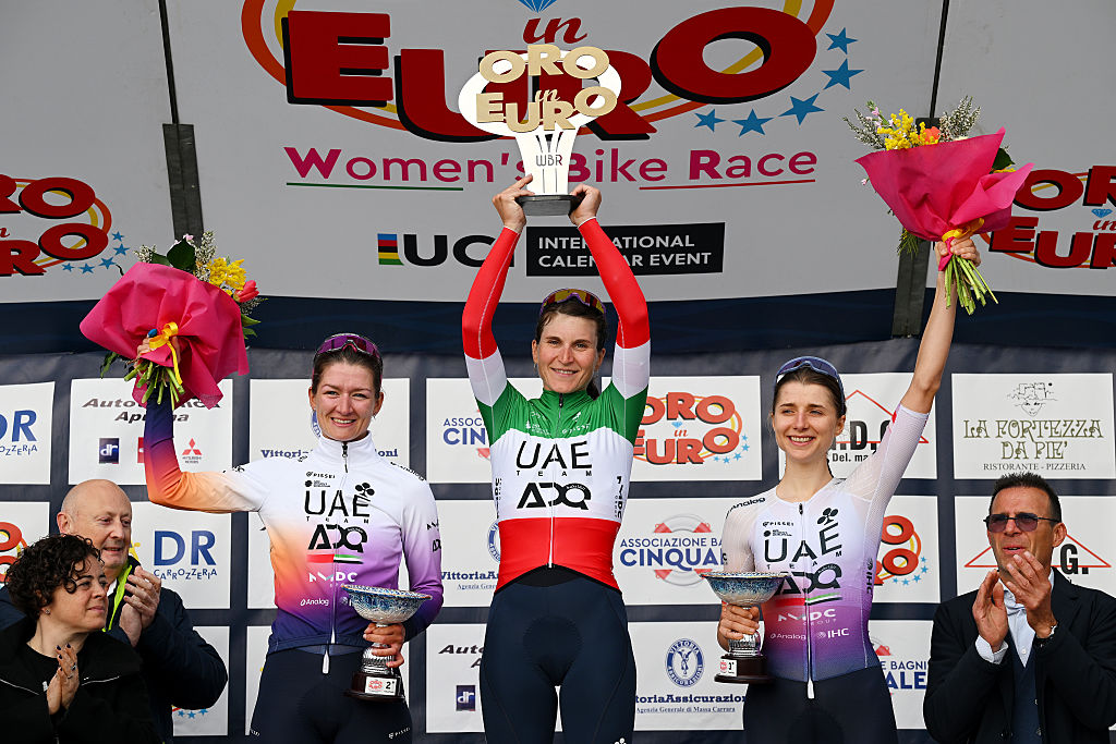 CINQUALE, ITALY - MARCH 08: (L-R) Karlijn Swinkels of Netherlands and UAE Team ADQ on second place, race winner Elisa Longo Borghini of Italy and UAE Team ADQ and Dominika Wlodarczyk of Poland and UAE Team ADQ on third place pose on the podium ceremony after the 14th Trofeo Oro in Euro 2026 a 106.8km one day race from Cinquale to Cinquale on March 08, 2026 in Cinquale, Italy. (Photo by Tim de Waele/Getty Images)