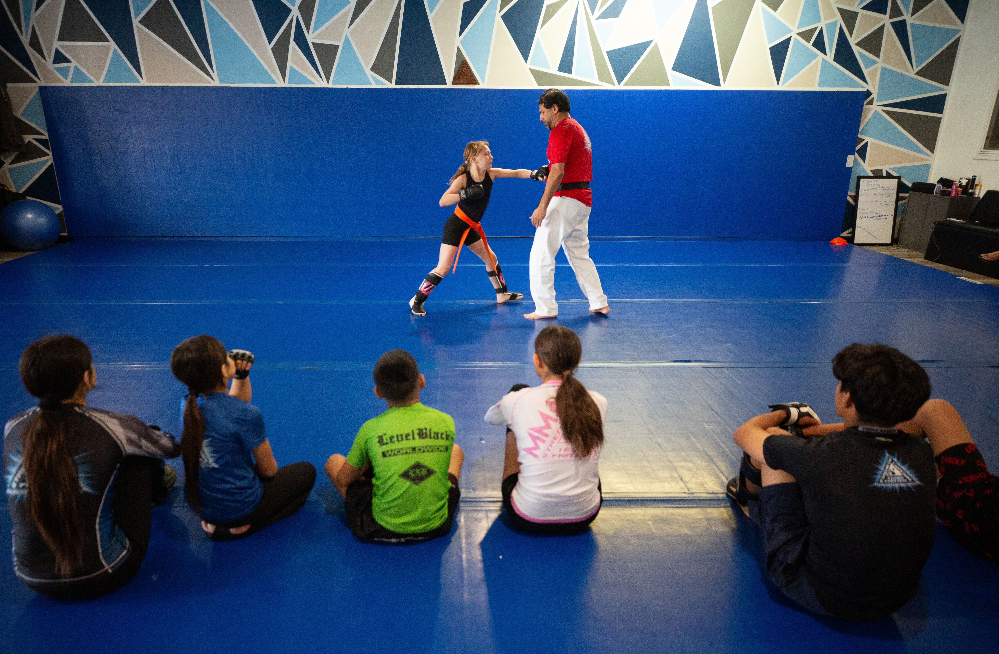 Jessie Kelly, 12, of Orange County, tries fighting techniques with...