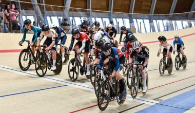 Cyclists riding on the velodrome track.