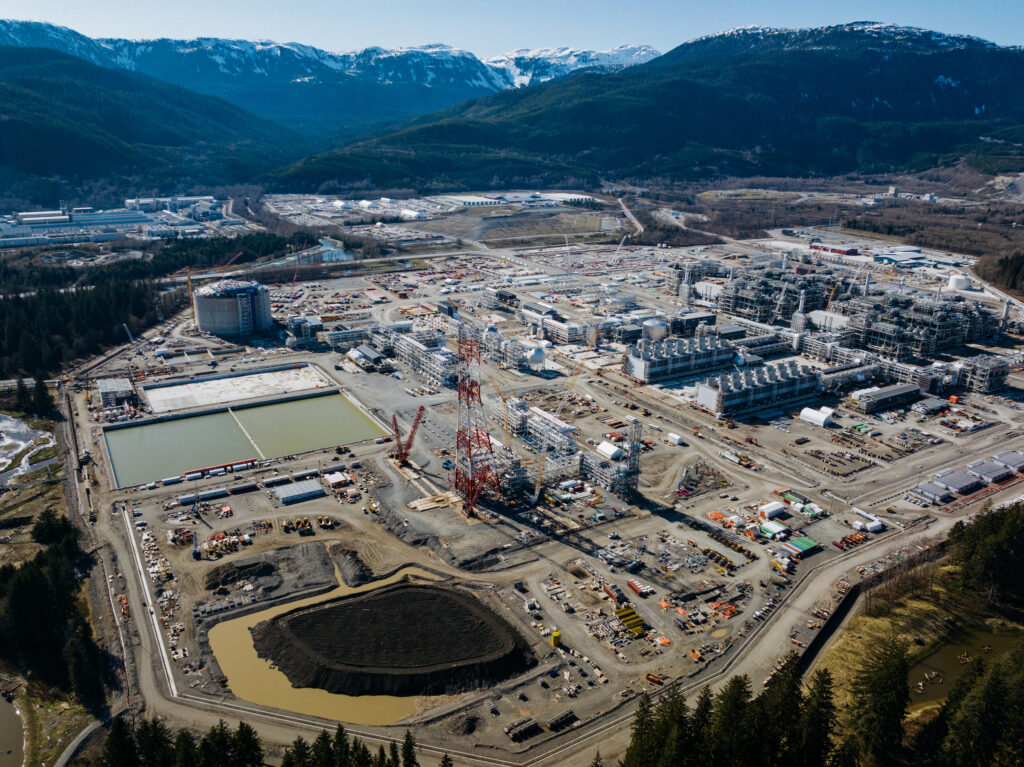 A view of LNG Canada project site in Kitimat, B.C., with mountains in the backdrop.