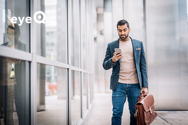 eyeQ businessman looking at stocks on smartphone