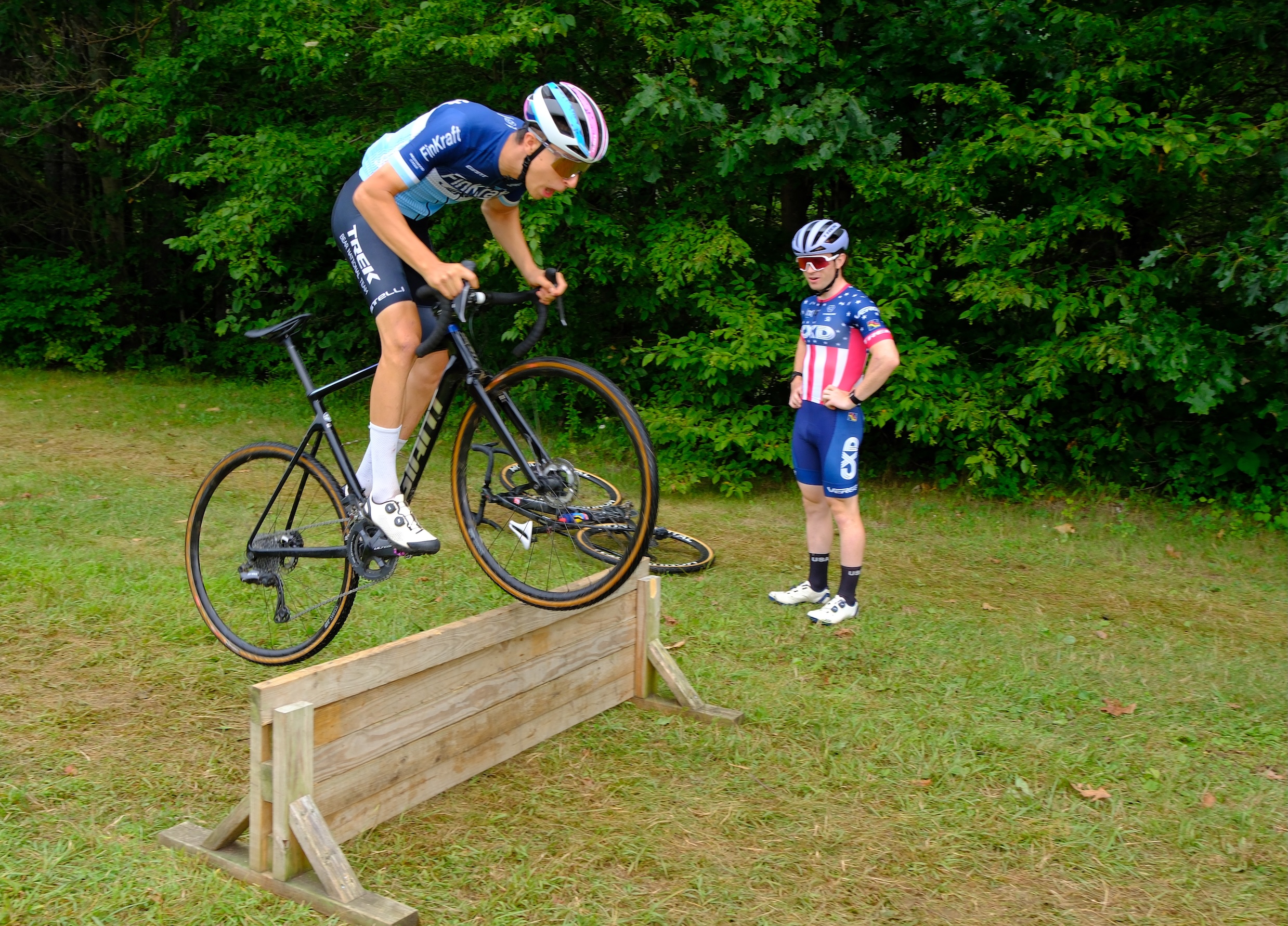 2025 Vermont ECA camp participant Noah Scholnick bunny-hops a barrier with Coach Andrew Strohmeyer looking on
