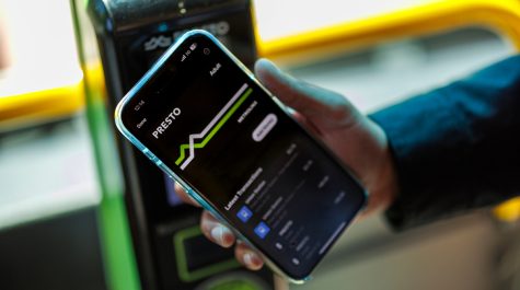 Hand holding a cell phone with the PRESTO app on the screen.