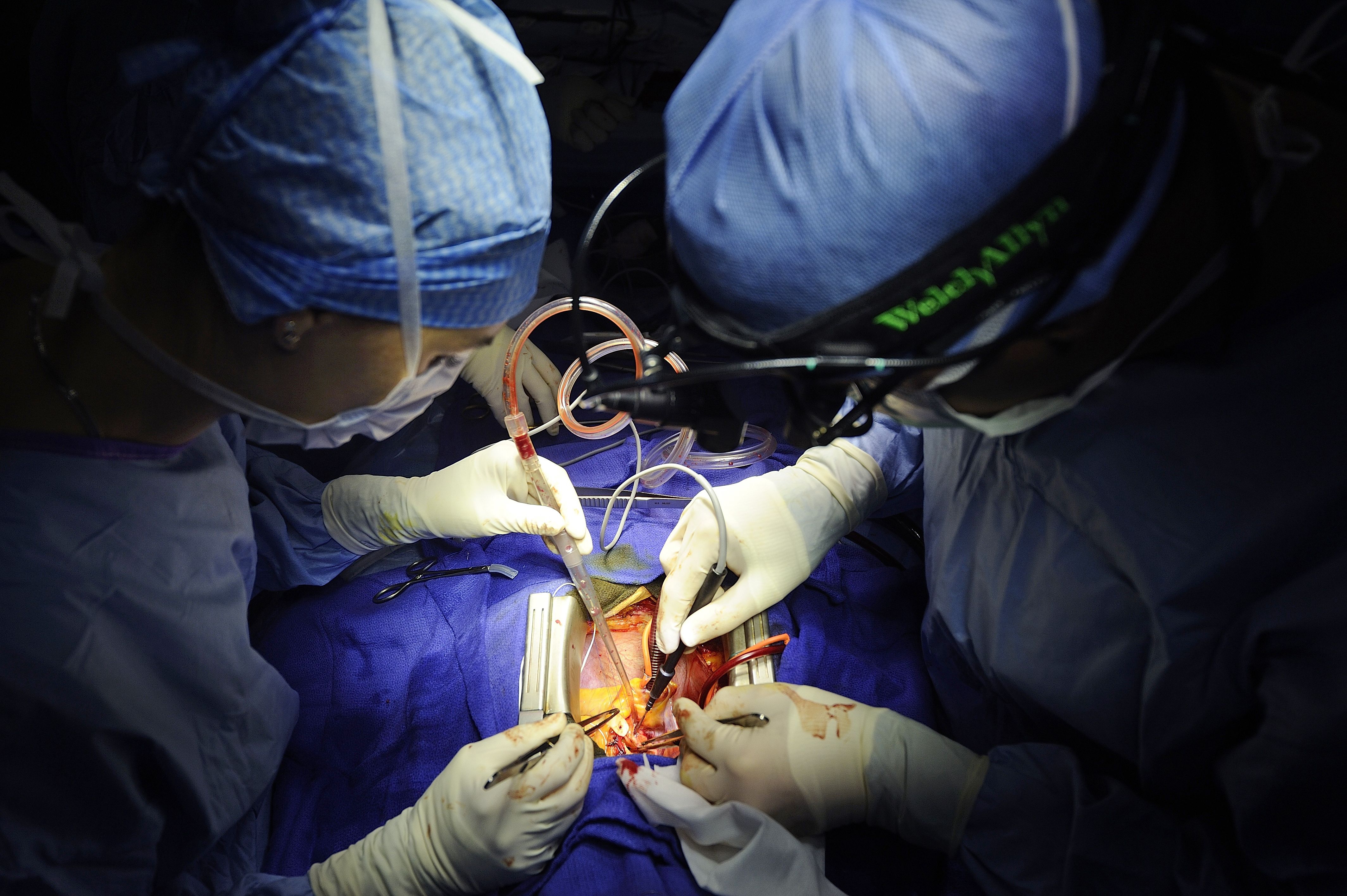 Surgeons operation on a heart patient