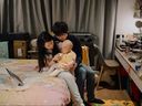 A family has a quiet moment while staying in a room provided by Ronald McDonald House Canada.
