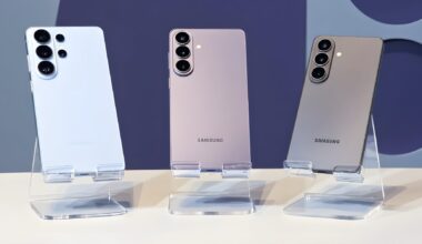 Three Samsung Galaxy smartphones in different colors are displayed on stands, showcasing their rear camera designs.