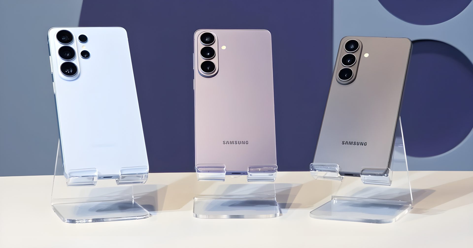 Three Samsung Galaxy smartphones in different colors are displayed on stands, showcasing their rear camera designs.