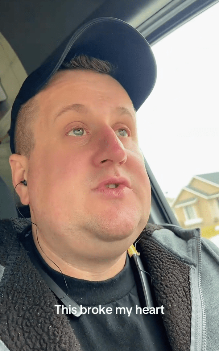 man crying in his car about being poor