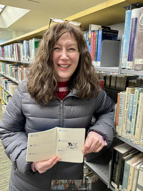 Marci Stepak holds library passport