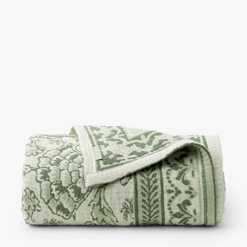green patterned coverlet