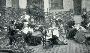 A black and white image of women having tea.
