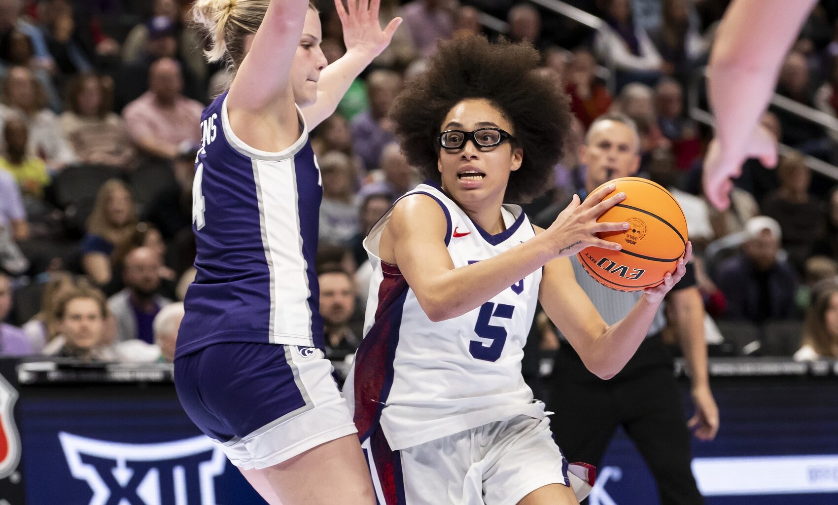Mar 7, 2026; Kansas City, MO, USA; TCU Horned Frogs guard Olivia Miles (5) attempts to drive the ball past Kansas State Wildcats forward Nastja Claessens (4) during the second half at T-Mobile Center.