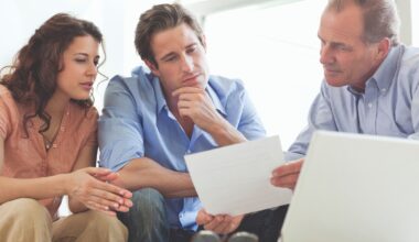 Three people looking at a piece of paper