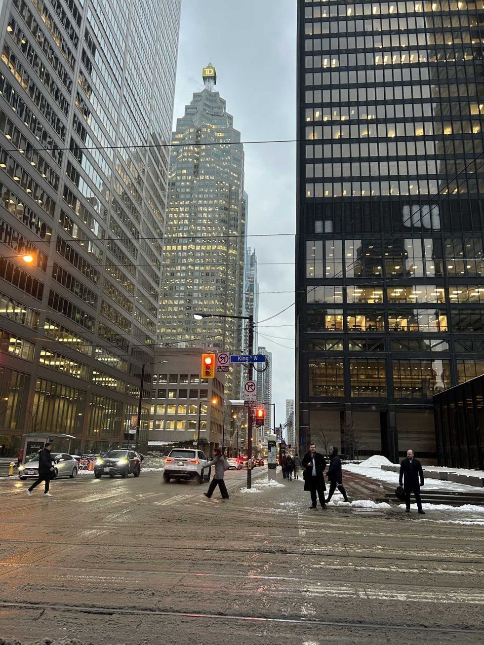 A downtown intersection with slush on the road.